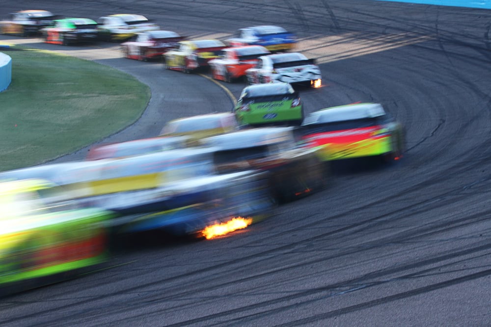 blurred image of racing track filled with cars