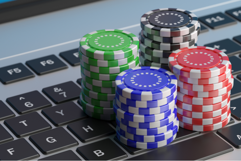 Poker chips stacked on a laptop keyboard